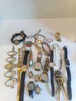 Group image of all 26 wristwatches and parts