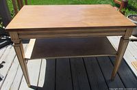 Full front and angled view of end table showing two tiers and leg design