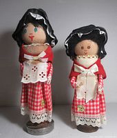 Front view of both Welsh bobbin dolls showing costumes and bases