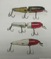 All three lures top view showing color, body style, hooks