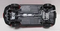 Underside showing exhaust and drivetrain detail of red 1:18 Alfa Romeo Spider model