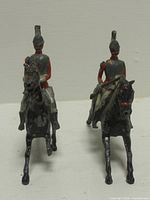Front view of both mounted figures