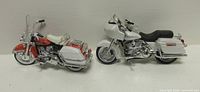 Side view of both model motorcycles showing paint schemes, saddlebags and seats