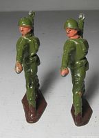 Rear view of both soldiers showing uniforms and stance
