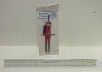 Compass in package and triangular ruler side-by-side