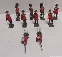 Group shot of eleven lead soldier figures showing two prone riflemen and nine standing figures