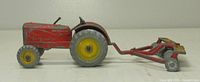 Left side view of tractor hitched to disc harrow