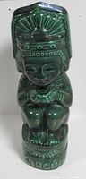 Front view of green ceramic Mt Kahlua tiki decanter