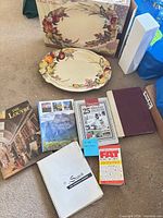 Group shot showing fruit motif platter, original box, and seven books