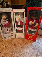 Three Motion-ettes of Christmas boxed figures: Santa, Mrs. Claus, elf