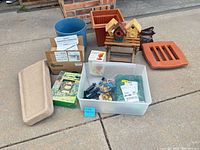 Full lot layout showing birdhouses, planters, solar parts, bells in tub