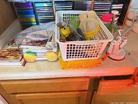 Overview of basket with utensils, cookbooks, recipe boxes and gadgets