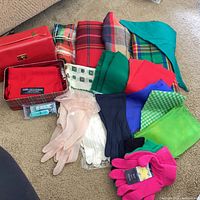 All items laid out: vanity case, multiple scarves, gloves, nail clippers