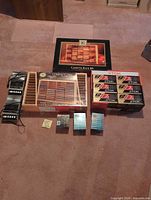 Group shot showing both Panasonic recorders, boxed wood cassette rack, boxed wood CD rack, two sealed 12-packs of TDK cassettes and additional sealed tapes