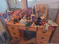 Wide view of desk with pennant, statues, radiometer, string art, swan, mug, board game