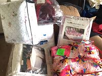 Group shot of packaged quilt, blankets and crocheted afghan