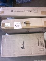 Three sealed Furinno shipping cartons labelled 5-Tier Bookshelf