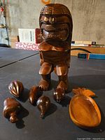 Group shot showing tiki statue, pineapple bowl and six carved fruit pieces