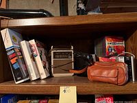 Shelf view with RCA radio, brown leather pouch, film boxes