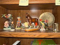 Overview of all figurines on bookshelf shelf