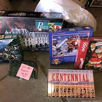 Overview of all boxed puzzles including Puzz3D, Centennial set, Springbok Santa, Up on the Rooftop, green box