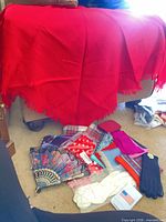 Overview of scarves, gloves, fan and pouch on floor