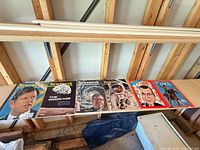 Six magazines laid out on shelf, all visible covers