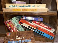 Shelf with multiple boxed board games and Ripley’s game visible