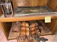 shelf view showing lantern, print, duck, ship, cart