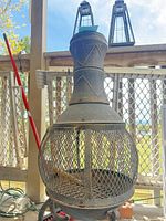 Front view of chiminea with two lanterns placed on top