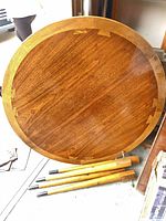 Full view of round tabletop and detached tapered legs
