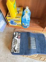 Group shot showing OxGord carpet mat, tan rubber mats, WaxMaster box, two blue washer fluid jugs