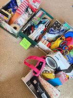 Overview of all boxes showing pens, scissors, rubber bands and tray with electronics