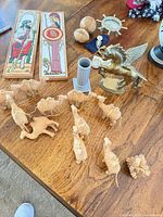 Overview of lot on table showing Pegasus, camels, puzzles, tiles, column, frame, jewelry