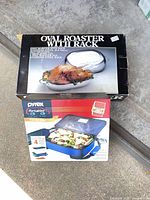 Both boxed items: oval roaster with rack box and Pyrex Portables glass dish set box