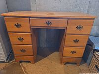 Front view of desk showing drawers and hardware