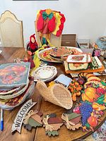 overview of tableware, linens, cornucopia, wooden sign, small pumpkins