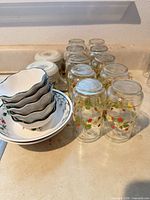 Stacked ramekin bowls, soup bowls and ten inverted tumblers