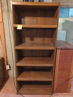Front view of bookcase showing five shelves and finish