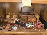 Overall lot on shelf showing wagons, horses, wooden box and accessories