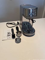 Full view of Breville Bambino machine with accessories laid out