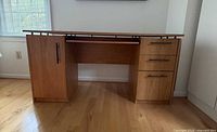 Front view of desk showing cabinet, drawers and overall shape
