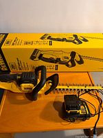 Hedge trimmer with charger and box
