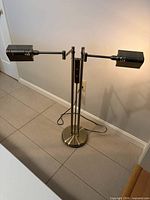 Full view of floor lamp showing twin arms extended and base