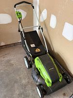 Full mower upright with handle and grass bag attached
