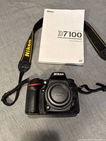 Camera body with strap and manual