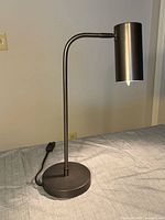 Full view of lamp showing base, arm, shade and cord
