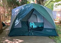 Tent fully assembled front view showing door, rainfly, overall condition