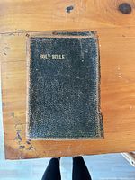 Front cover of 1901 Holy Bible showing black pebbled leather and gilt title