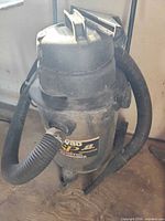 Full view of Shop-Vac showing hose and label